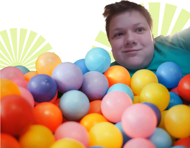 Brody in a ball pit with a big smile